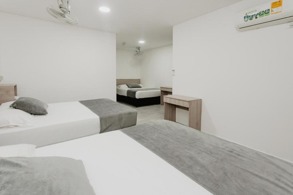 Postel nebo postele na pokoji v ubytování Hotel Plataneras Caney