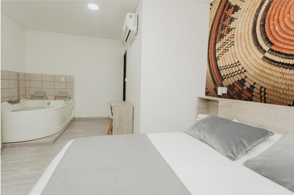 Postel nebo postele na pokoji v ubytování Hotel Plataneras Caney