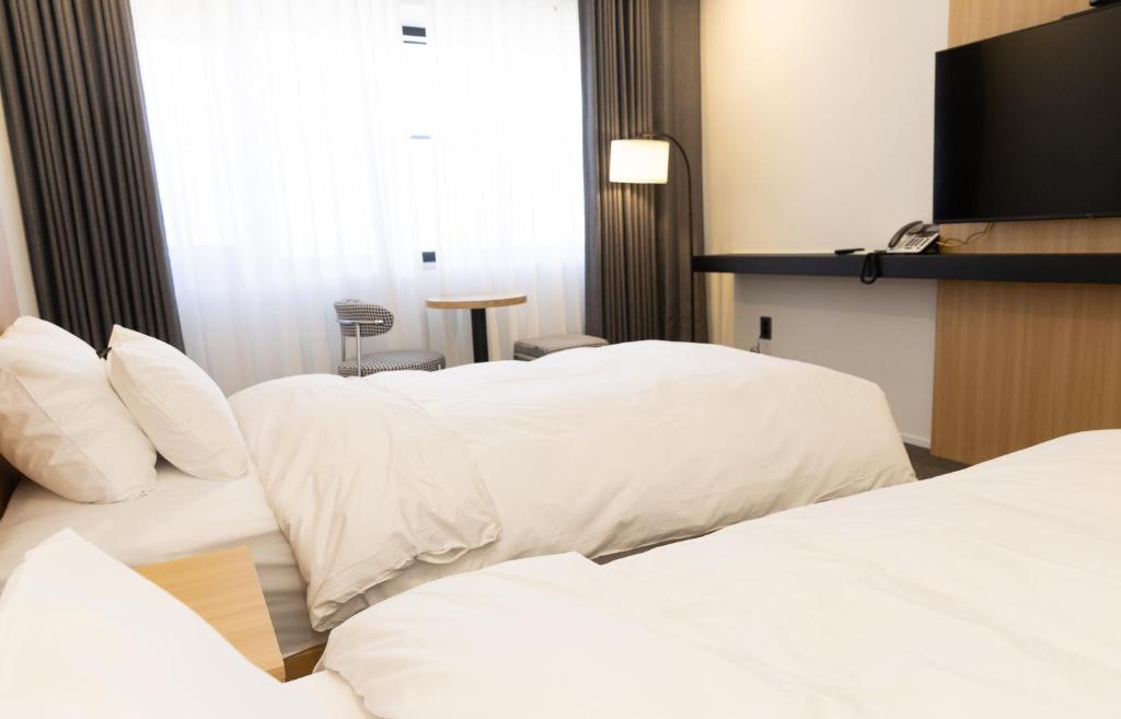 Postel nebo postele na pokoji v ubytování Southernheal Hotel