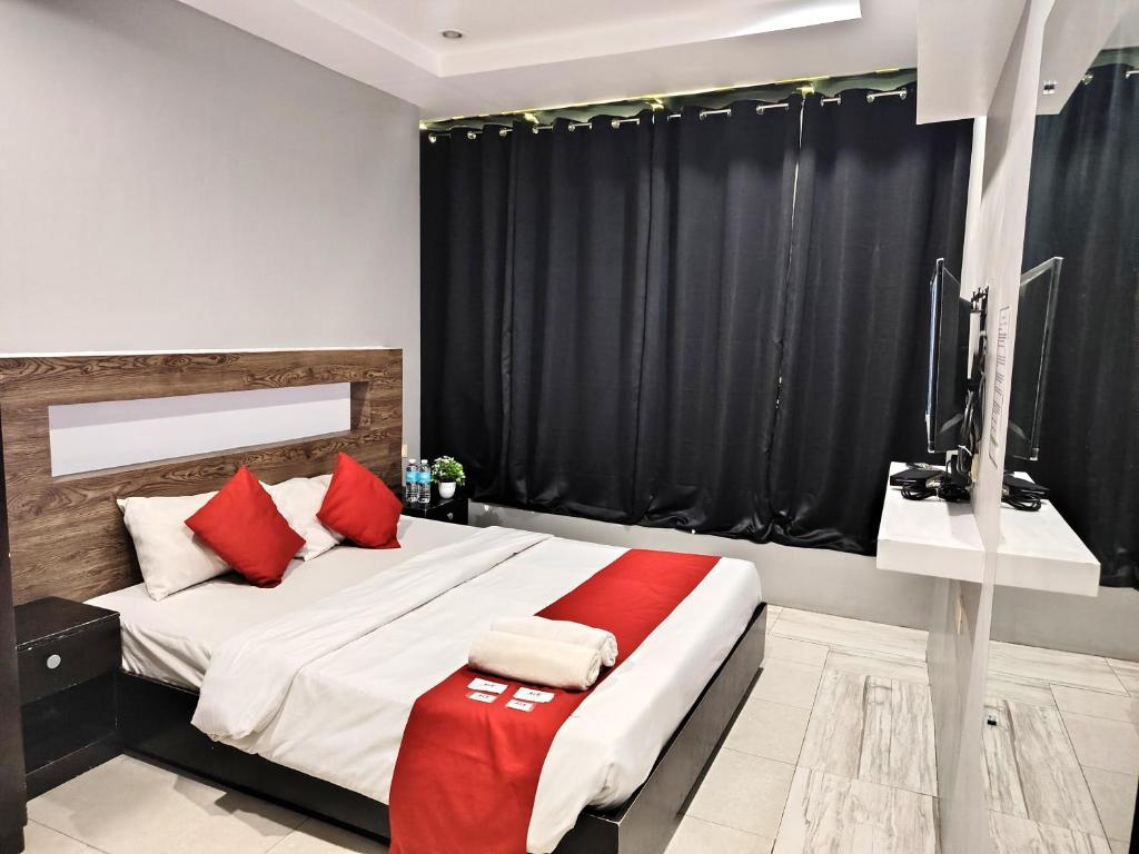 Postel nebo postele na pokoji v ubytování The JRJF Hotel near Tagum Terminal