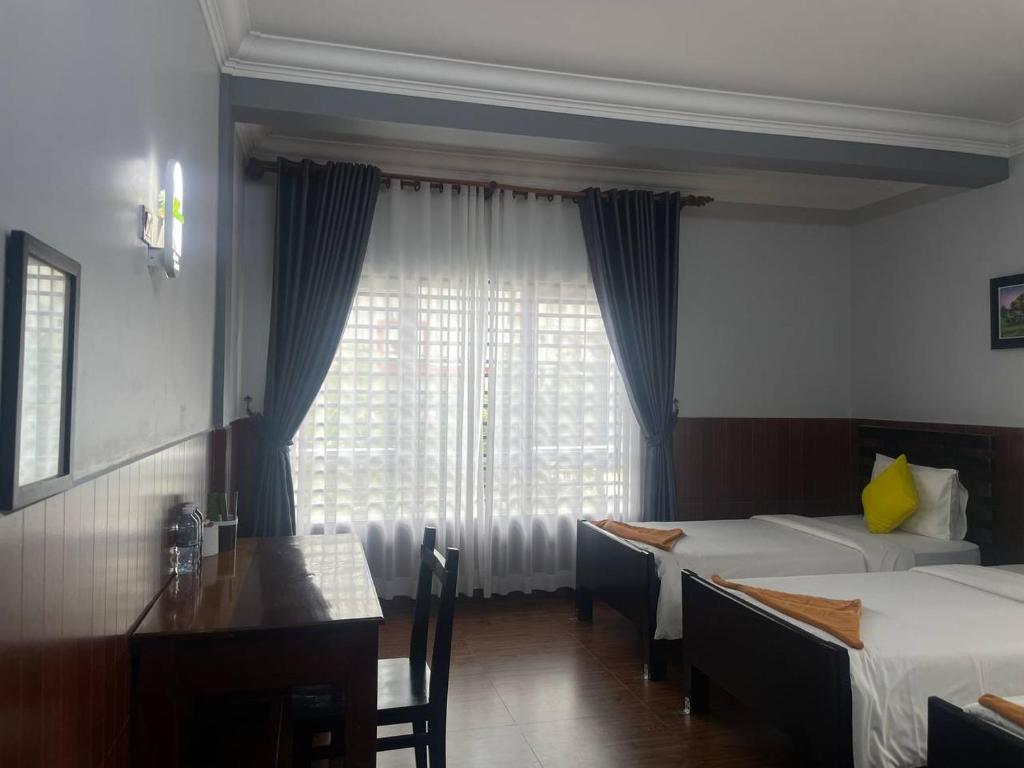 Postel nebo postele na pokoji v ubytování Jasmine Lodge Siem Reap