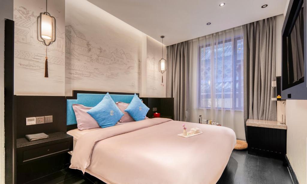 Postel nebo postele na pokoji v ubytování Gongxili - Chujian Hotel