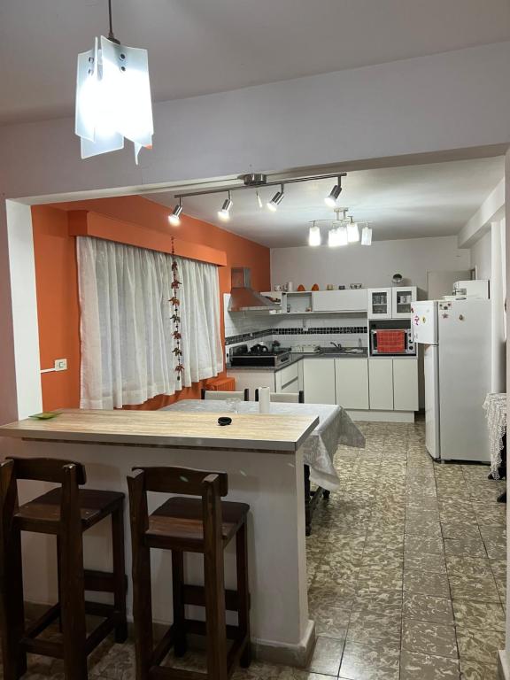 a kitchen with a large table and chairs in it at Departamento La Paz in La Falda