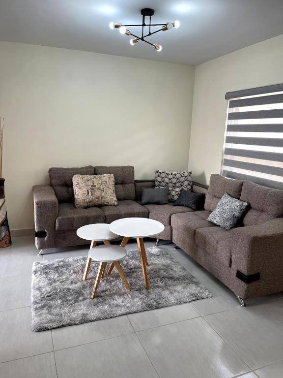 a living room with a couch and a table at Hermosa casa entera cerca de la Presa del Rejón in Chihuahua