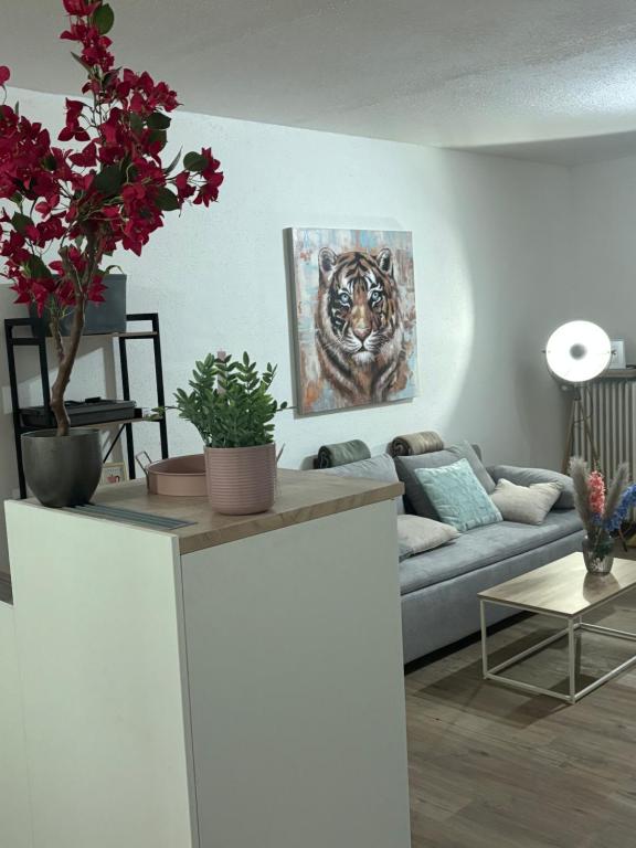 a living room with a couch and a painting of a tiger at Emsquartier Apartment No 2 in Emsdetten