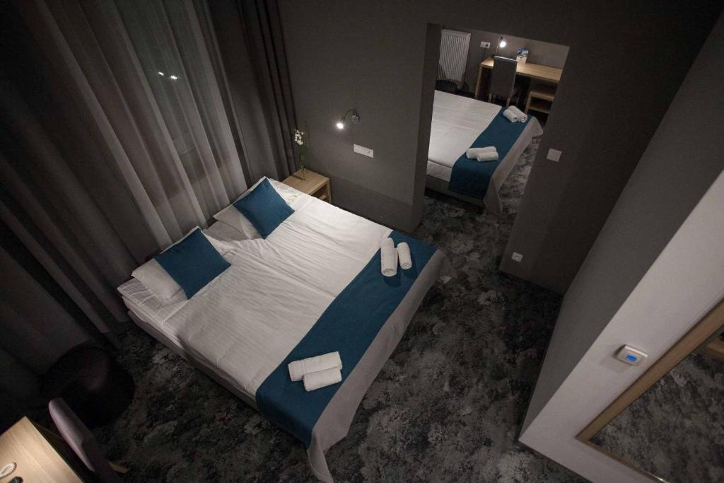 Postel nebo postele na pokoji v ubytování Hotel Zatoka