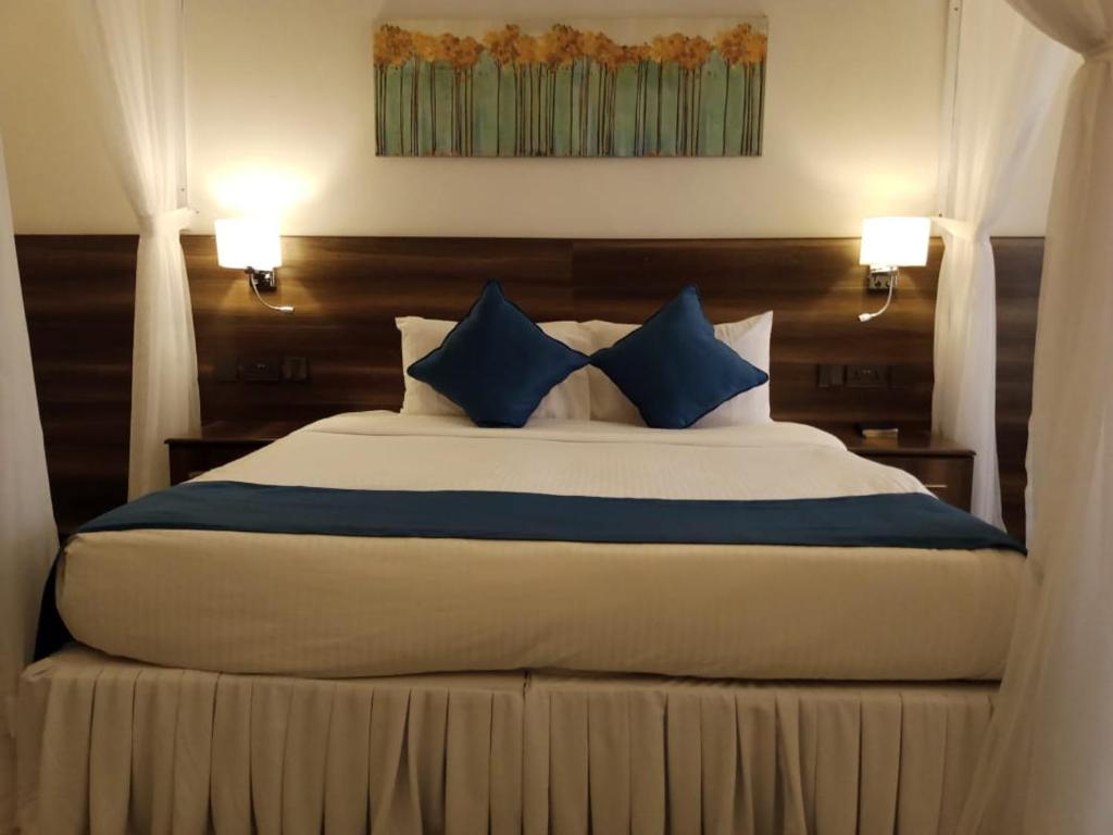 Postel nebo postele na pokoji v ubytování Lukenya Alkebu Resort
