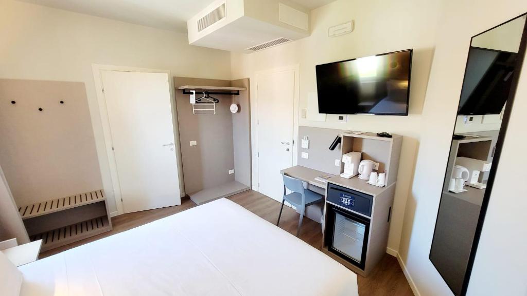 a small room with a desk and a tv at Hotel Aurora Duino in Duino