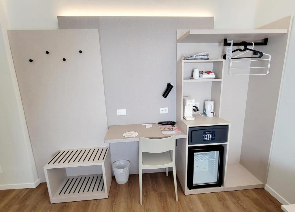 a small room with a desk and a table at Hotel Aurora Duino in Duino