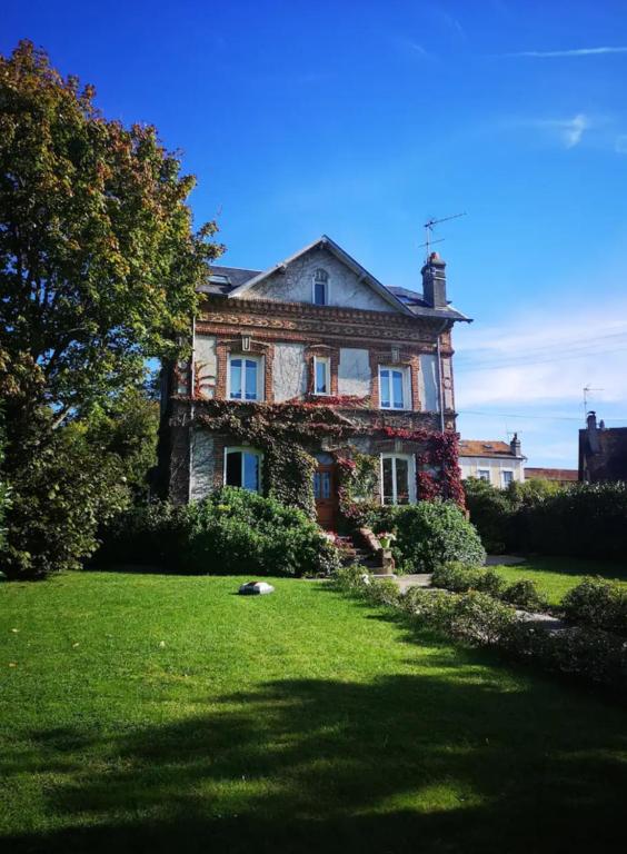 - une ancienne maison en pierre avec du lierre dans l'établissement Cosy villa, near beach, à Touques