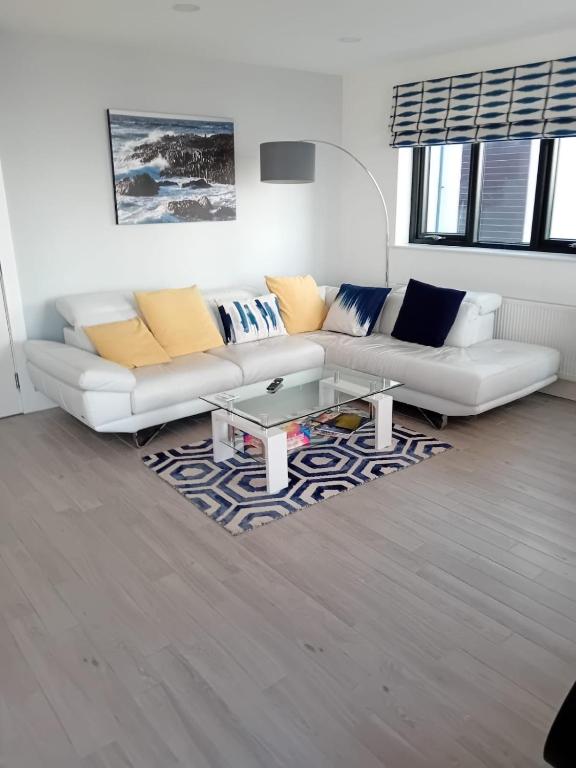 a living room with a couch and a coffee table at Beach View, Portballintrae in Portballintrae