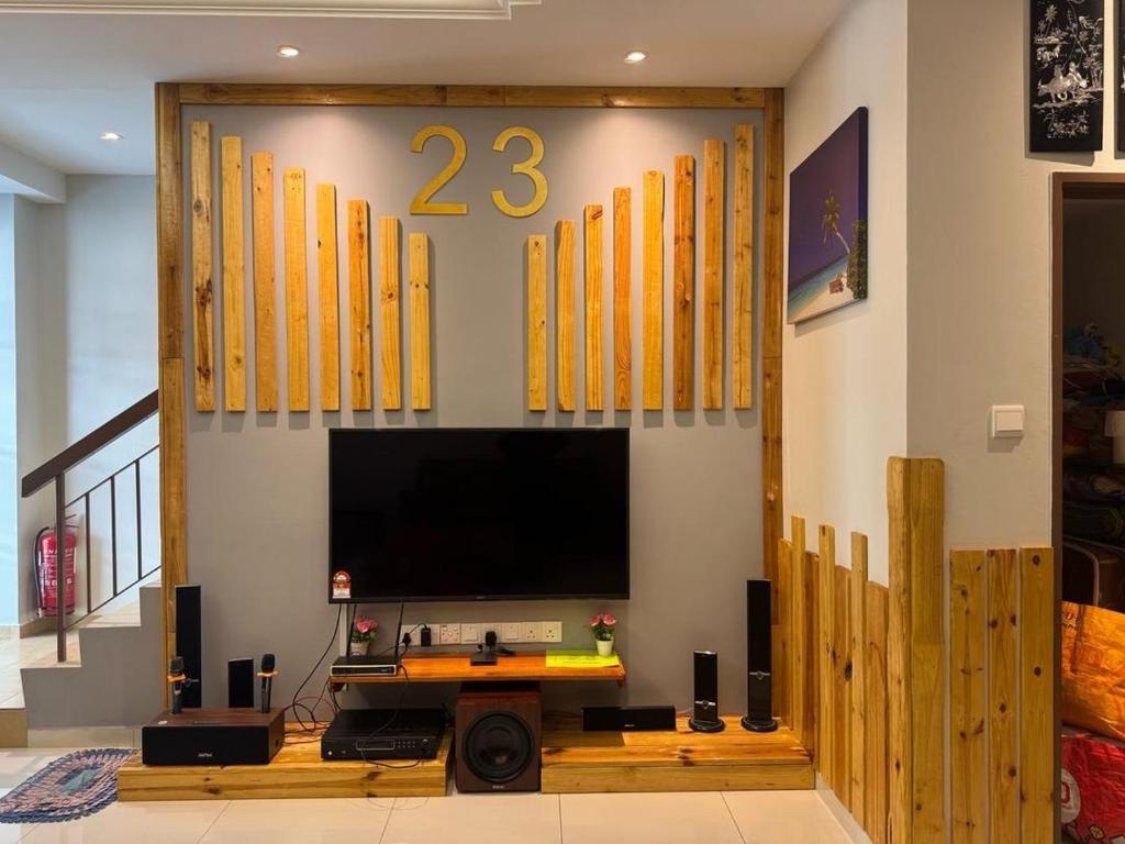 a living room with a flat screen tv in a room at L23 ,88 Resort Villa House in Pangkor