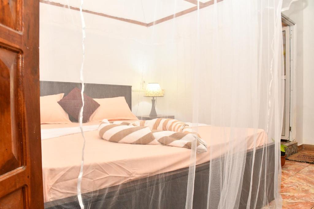 Postel nebo postele na pokoji v ubytování Ulla Arugam Bay