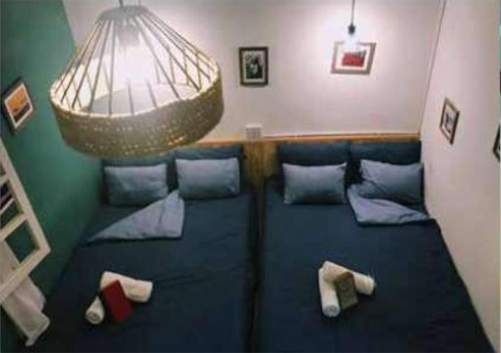 a living room with a blue couch with pillows at In The Pines Homestay & Coffee in Da Thanh