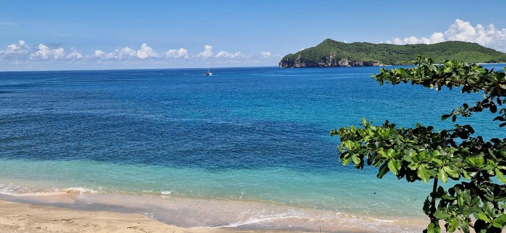 a view of a beach with a boat in the water at Castaway Surf Retreat in Sekongkang