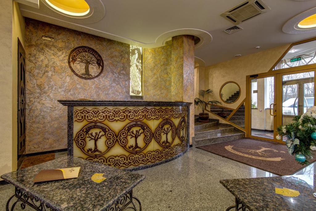 a lobby with a fireplace in a building at Khan-Chinar Hotel in Dnipro