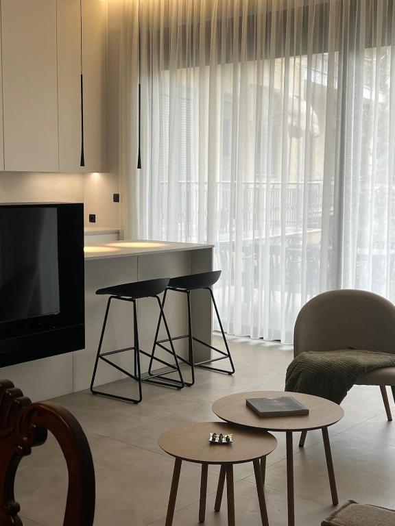 a living room with a television and a table at Zero Point Nafpaktos in Nafpaktos