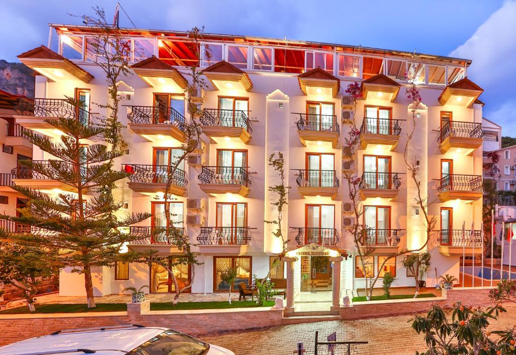 a building with a car parked in front of it at Hotel Kayahan in Kaş