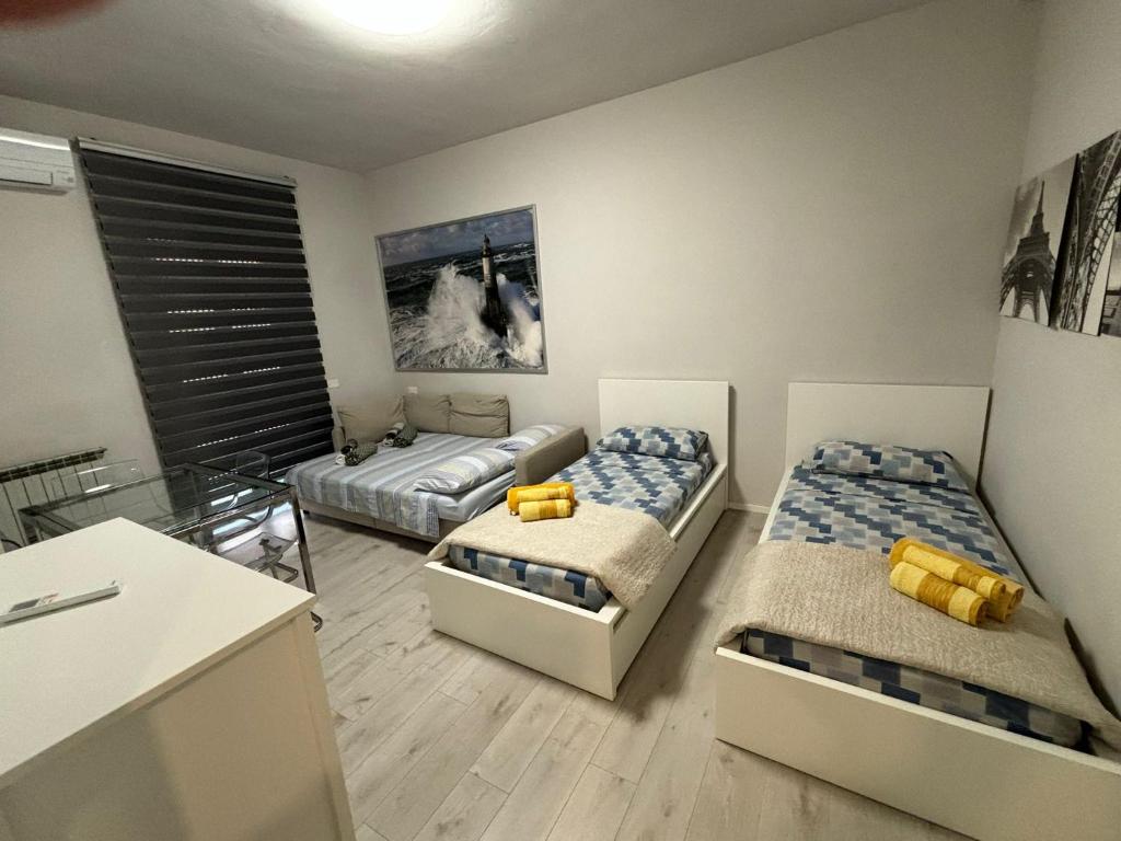 a room with two beds in it with a counter at VVR6 Apartment by Homes in Ancona in Ancona