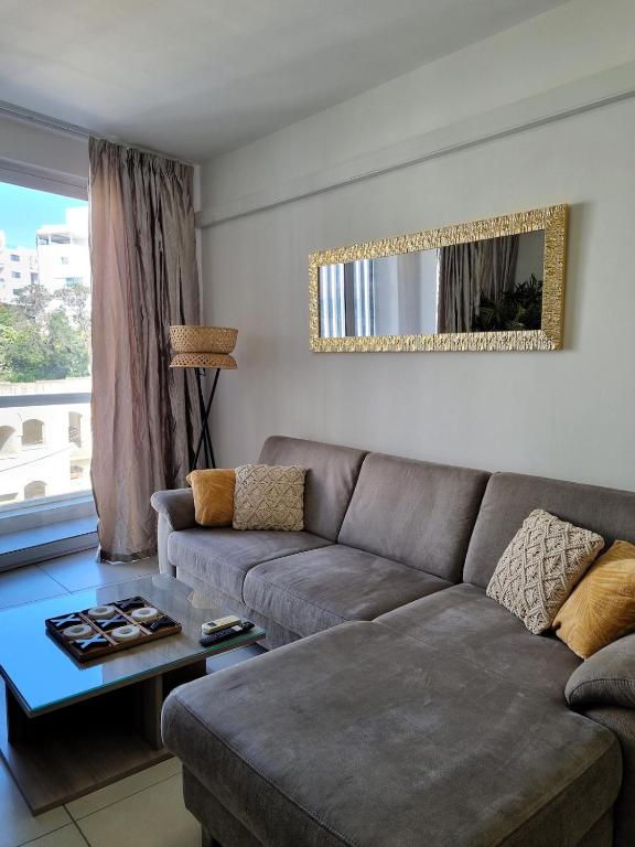 a living room with a couch and a table at Bay Water 21 in St. Julianʼs