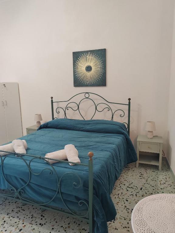 a blue bed with two pillows on it in a bedroom at La casa di Maria in Lipari
