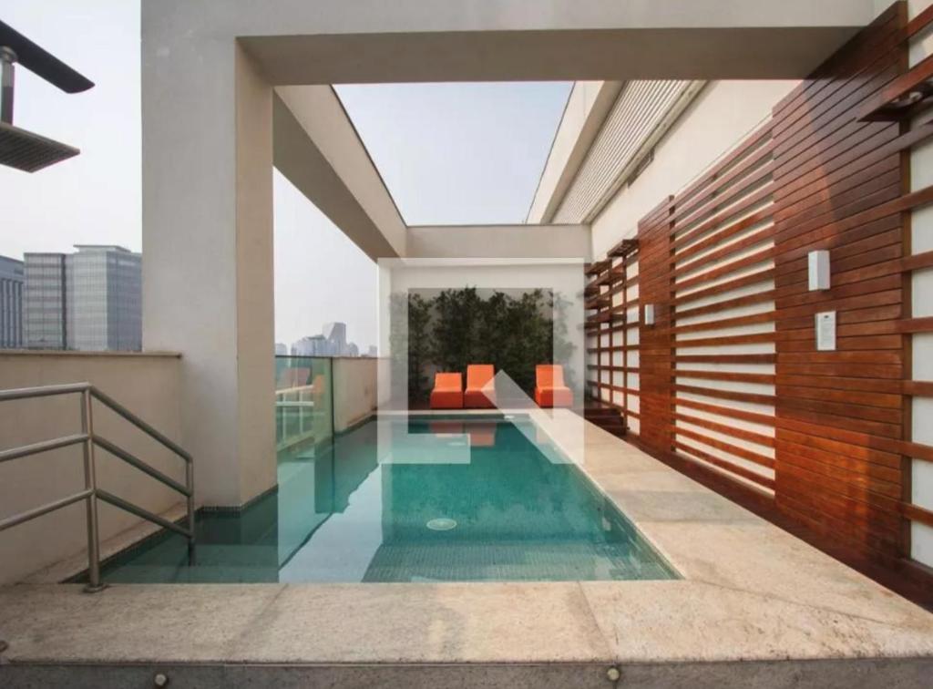 a swimming pool in the middle of a house at Loft Moderno - High Security And Garage Shoppings in Sao Paulo