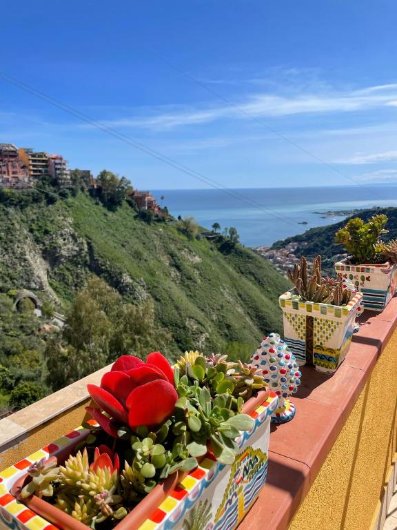 a table with fruits and vegetables on top of a balcony at Tao enJoy Suite in Taormina