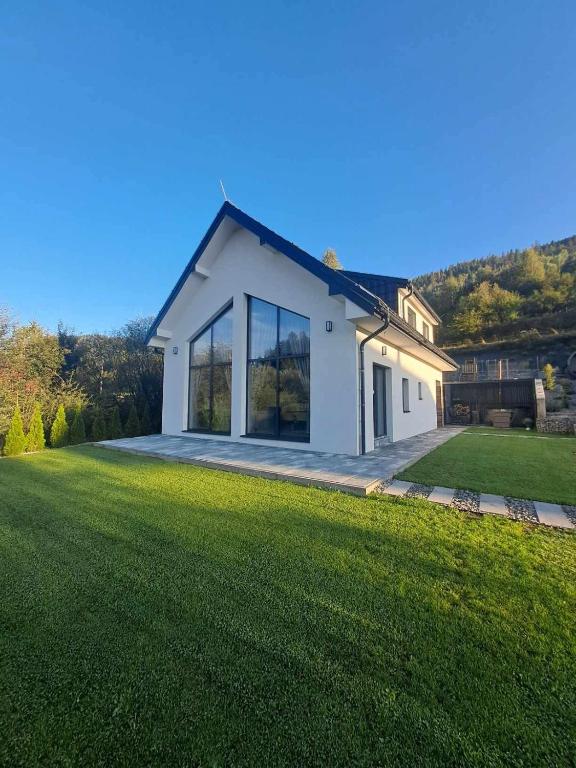 a house with a large lawn in front of it at Chalet Habovka in Habovka