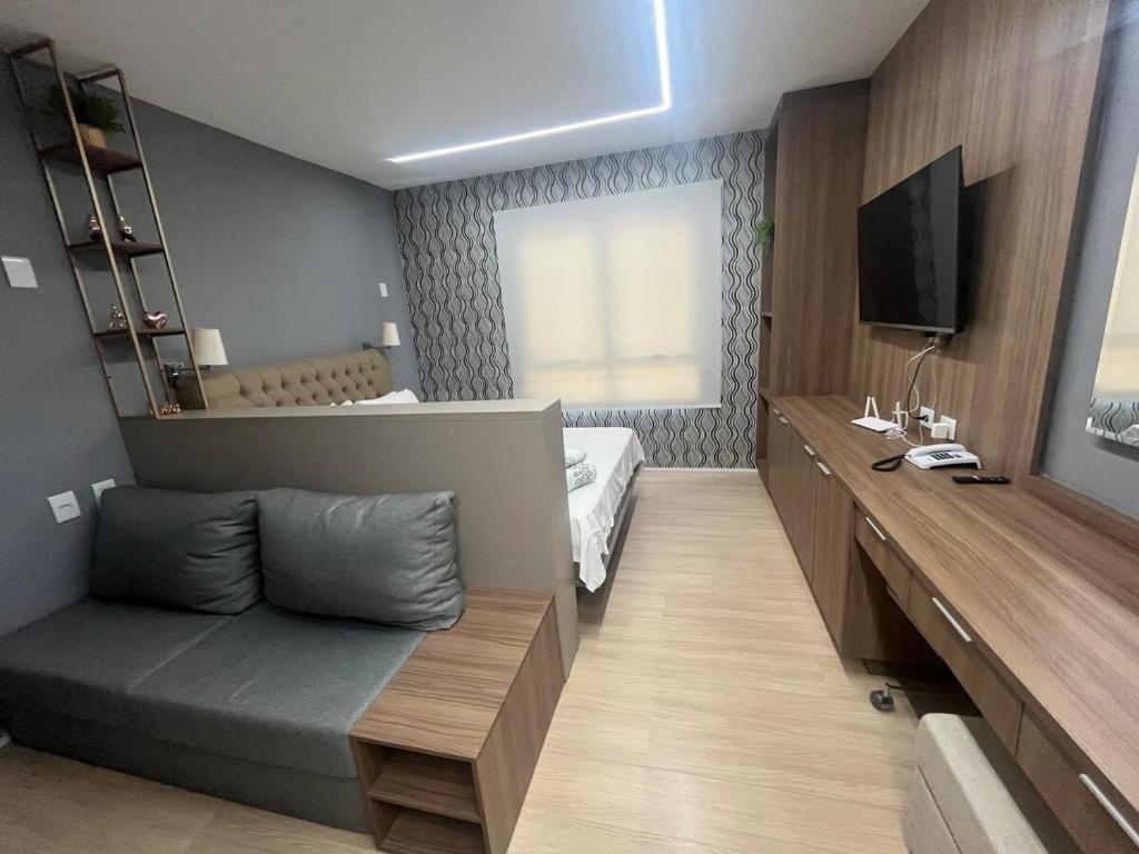 a bedroom with a bed and a tv in it at BLEND MARISTA! Compacto de Luxo no bairro mais nobre da cidade! in Goiânia