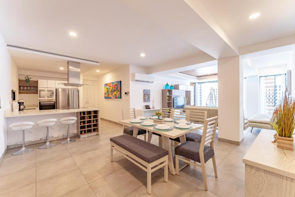 a kitchen and dining room with a table and chairs at Bright and nice 3 Beds close to 5th in Playa del Carmen