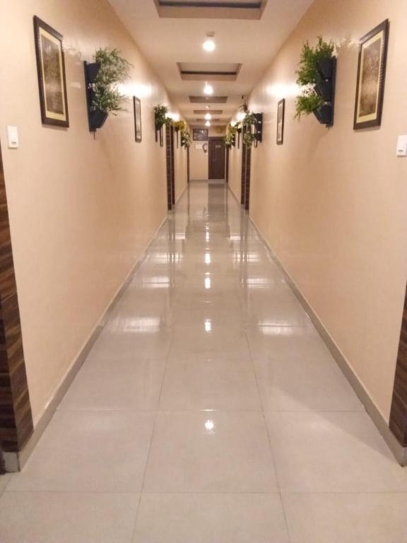 an empty hallway with plants on the walls at Hotel S R in Lucknow