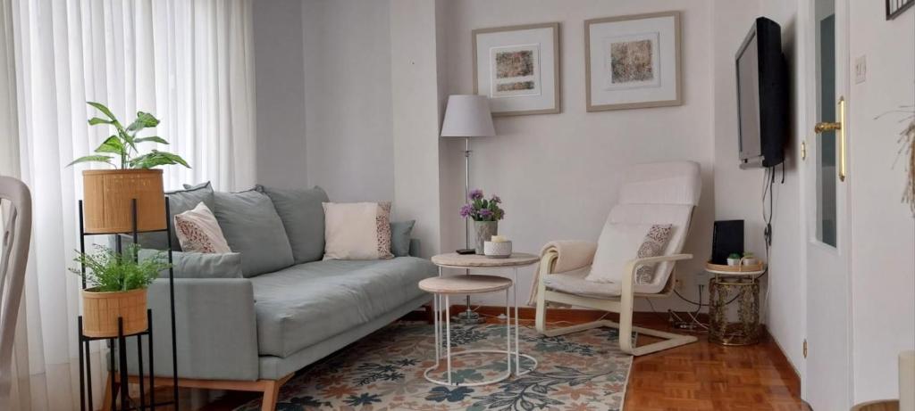 a living room with a couch and a table and chairs at Solerma in Viveiro