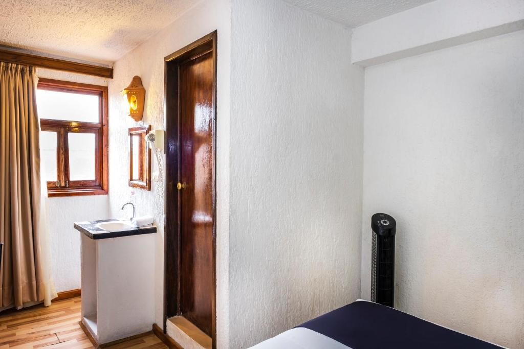 Postel nebo postele na pokoji v ubytování Capital O Hotel Central, Xalapa