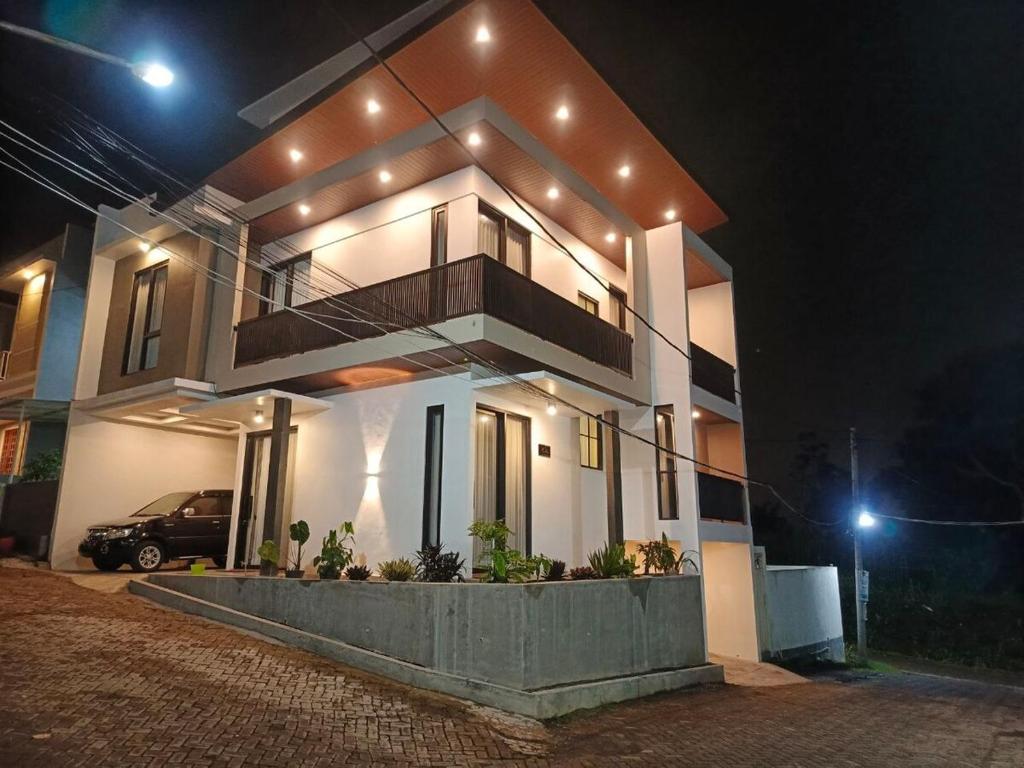 a house with a car parked in front of it at night at Papi Villa O3 in Tlekung