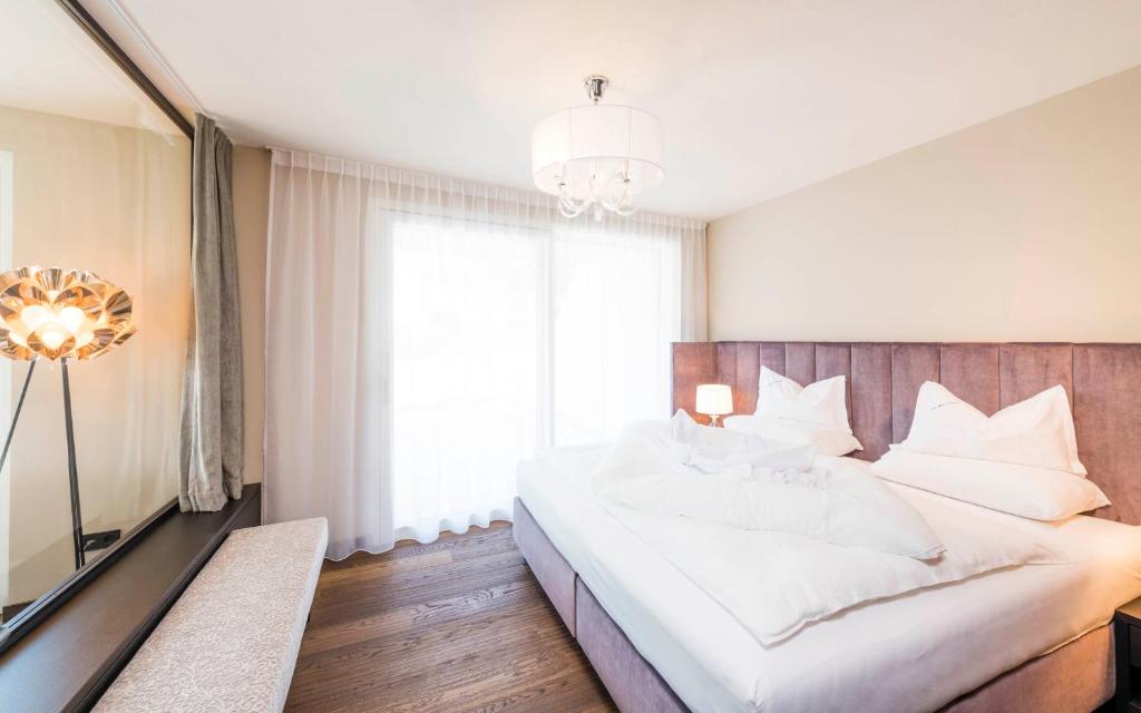 Posteľ alebo postele v izbe v ubytovaní Prunner Luxury Suites - Adults Only