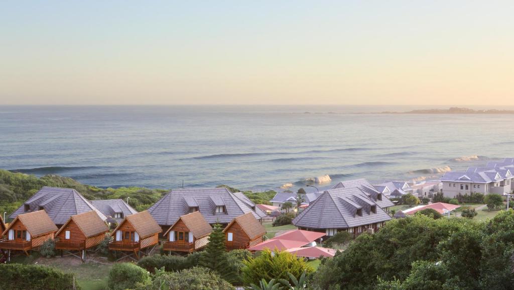 an aerial view of houses and the ocean at Brenton on Sea Cottages in Brenton-on-Sea