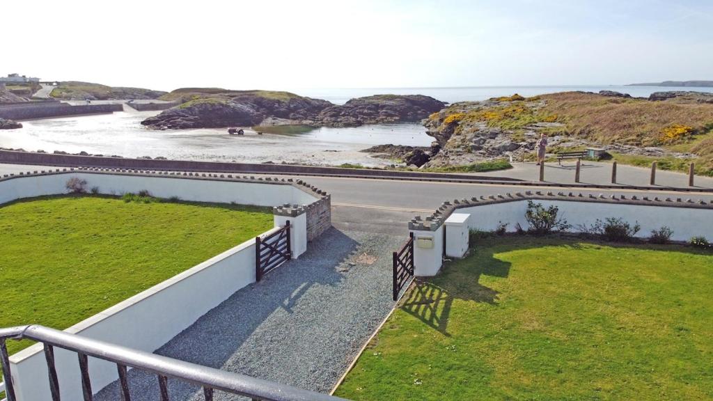 a view of the ocean from the balcony of a house at Porth House-Beach Front-3 Bed-3 Bath - SPA POOL and SAUNA in Trearddur