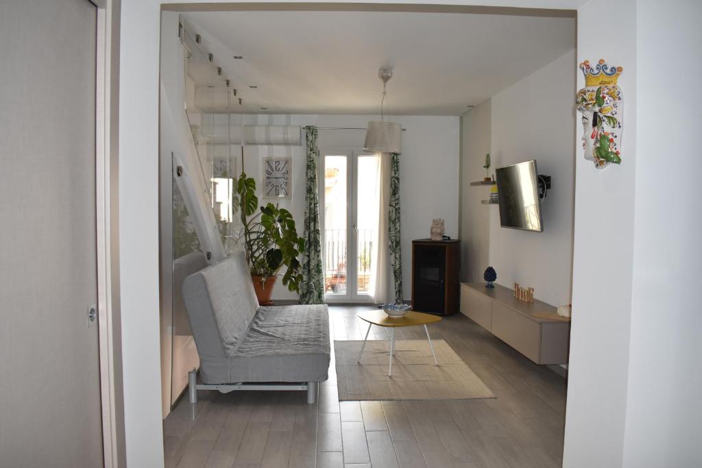 a living room with a couch and a chair at CASA della GIOIA in Caltagirone