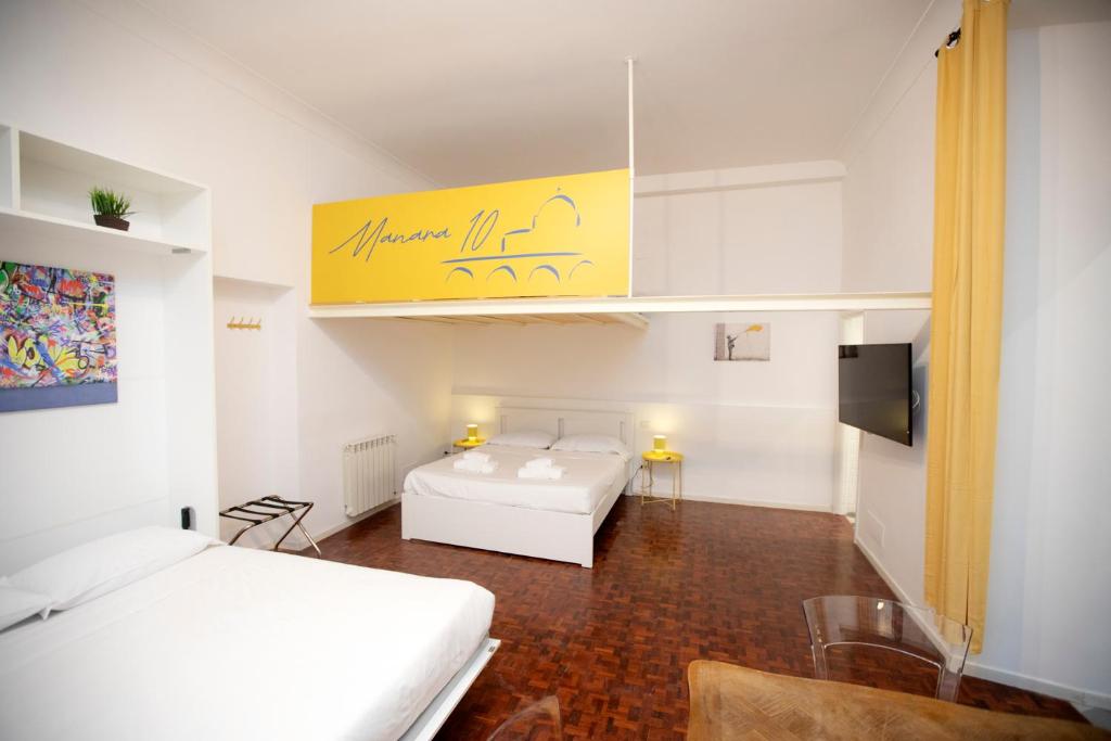 Ένα ή περισσότερα κρεβάτια σε δωμάτιο στο Manara10 Apart giallo2