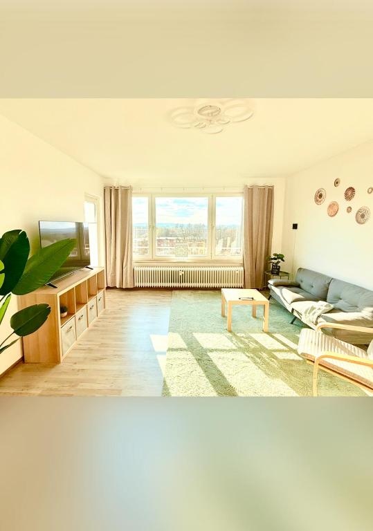 a living room with a couch and a tv at Panorama Lodge in Salzgitter