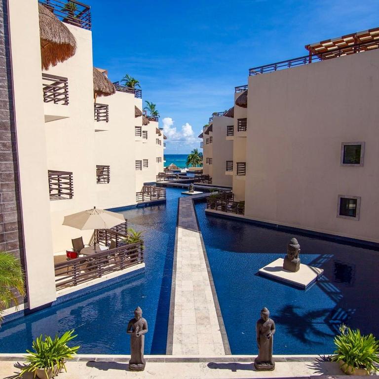 a swimming pool in the middle of a building at Awesome apartment at Aldea Thai Beachfront in Playa del Carmen