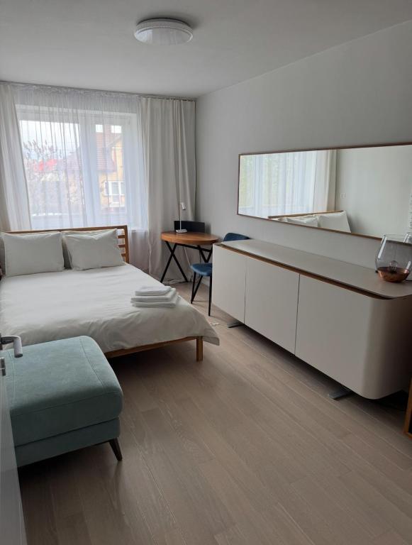 a bedroom with a large bed and a desk at es studio in Staszów