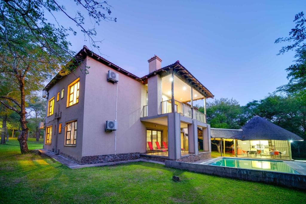 a large house with a pool in front of it at Mshengu Kruger Lodge in Marloth Park