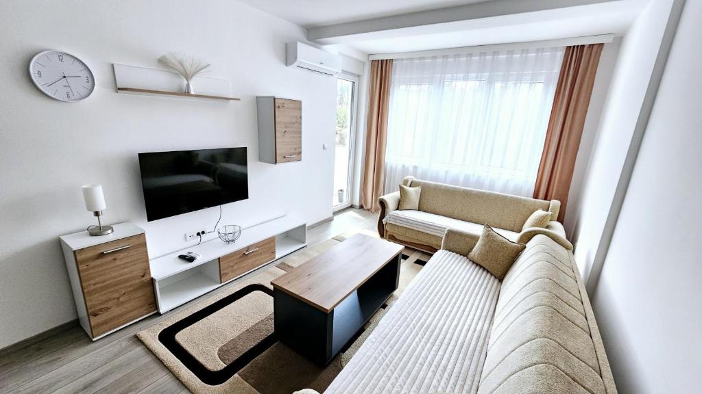 a living room with a couch and a tv at Apartman Car in Novi Pazar