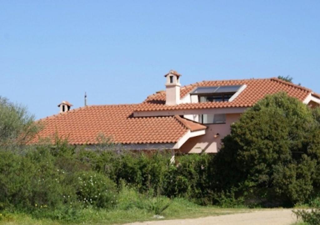 a large house with a red roof at Exclusive Sardinian Villa 300 mt from the beach in Àrbatax
