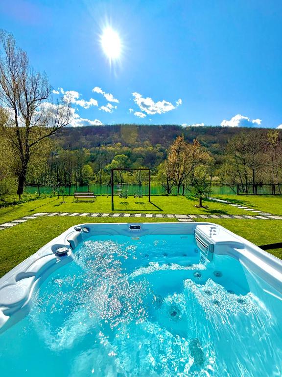 a jacuzzi tub with a view of a park at Aqua Vita Concept in Bihać