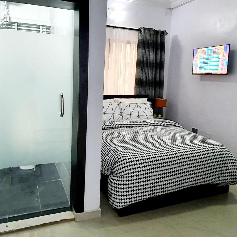 Postel nebo postele na pokoji v ubytování Dantis Apartments Magodo