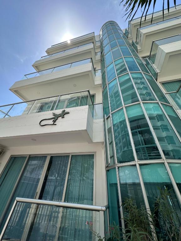a building with a large glass building with a clock on it at Hotel Rodadero Suites By SGH in Santa Marta