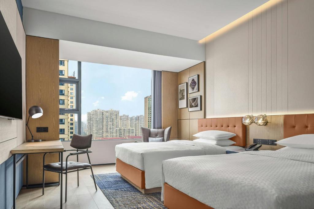 Postel nebo postele na pokoji v ubytování Four Points by Sheraton Hengyang Zhengxiang