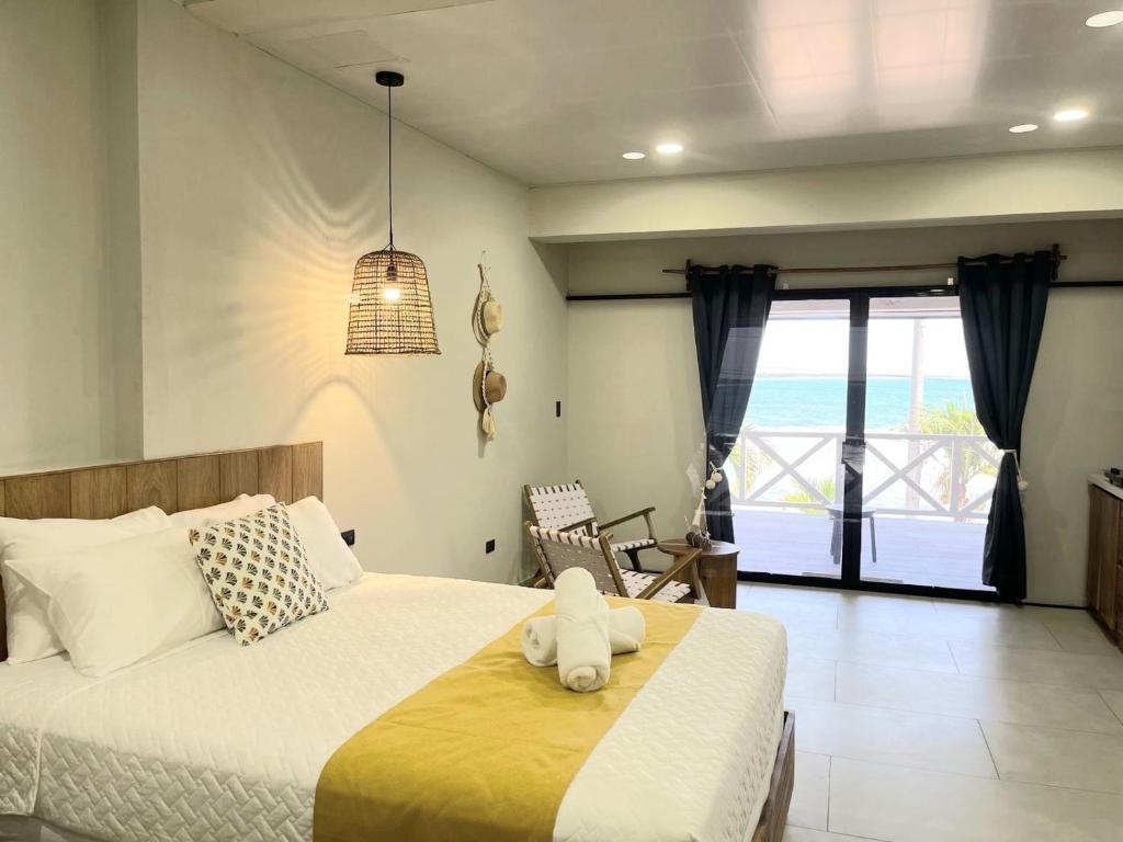 a bedroom with a bed with a stuffed animal on it at Litos Hotel in La Libertad